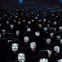 a large group of people wearing anonymous masks and top hats are sitting in a dark room .