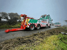 a heavy rescue tow truck is pulling another vehicle