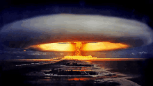 a large mushroom cloud rises over a small island in the ocean