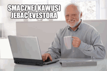 an older man sitting at a desk with a laptop and a cup of coffee with the caption smacznej kawusi jebac evectora