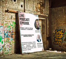 a sign advertising a live podcast episode is hanging on a brick wall