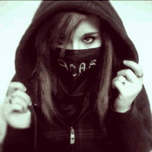 a girl wearing a black scarf that says a.a.r. on it