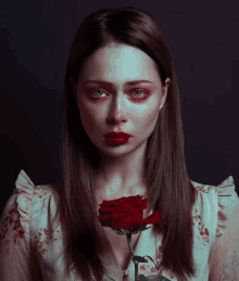 a woman with a red rose in her hand and a tear running down her face