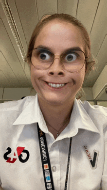 a woman wearing glasses and a lanyard that says ' cctv ' on it