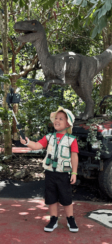 a little boy taking a picture of a dinosaur