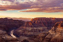 a canyon with a river running through it at sunset