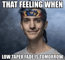 a man wearing a headband that says that feeling when low taper fade is tomorrow on it .