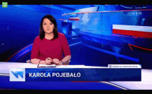 a news anchor with the name karola pojebalo on the bottom of her screen