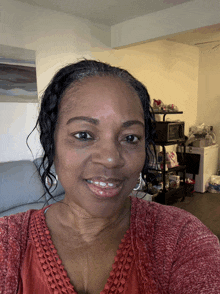 a woman wearing a red shirt is smiling for the camera