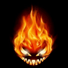 a halloween pumpkin is surrounded by flames and has a glowing mouth .