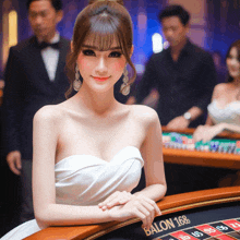 a woman in a white dress sits at a roulette table that says ballon 168 on it