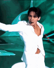 a man in a white shirt and white pants is dancing