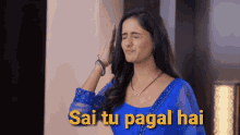 a woman in a blue dress with the words sai tu pagal hai on the bottom right