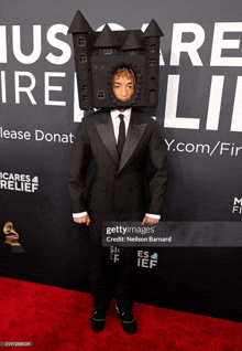 a person wearing a suit and tie with a castle on their head