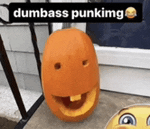 a pumpkin with a face carved into it and the words dumbass punking