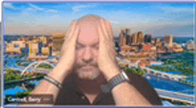 a man is holding his head in front of a cityscape