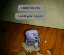 a purple stuffed animal is sitting on a wooden floor next to a wall with a text message .