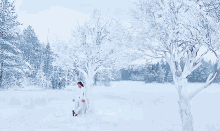 a man and a woman are standing next to each other in the snow and the woman is touching the man 's face