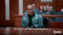 a man in a green jacket is sitting at a table in a courtroom and says dice will be representing dice .