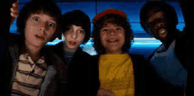 a group of young boys are standing next to each other in a dark room .