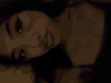 a close up of a woman 's face in the dark .