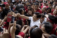 a man and a woman are surrounded by a crowd of people