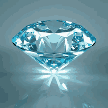 a large blue diamond is sitting on a shiny surface