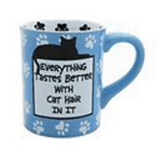 a blue mug with a black cat on it that says everything tastes better with cat hair in it .