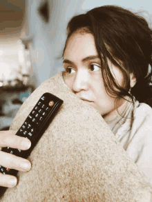 a woman holding a remote control with the numbers 1 2 3 4 5 6 7 8 9 and 10 on it