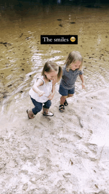 two little girls playing in the water with the words the smiles written above them