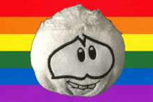 a white ball with a smiley face on it is against a rainbow flag