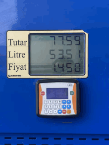 a digital display shows the price of a litre of gas