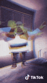 shrek is dancing in front of a window on a tiktok video