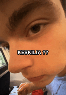 a close up of a person 's face with the words " keskilia " written above it