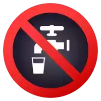 a no drinking sign has a faucet and a cup in it