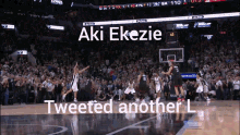 a basketball game is being played in front of a crowd and the player aki ekezie tweeted another l