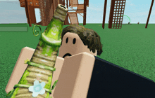 a person in a video game is holding a green object with a flower on it