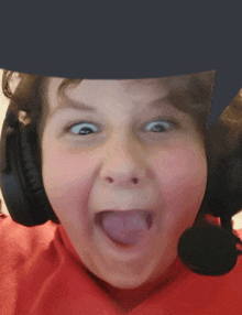 a young boy wearing headphones making a funny face with his tongue out