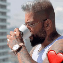 a man drinking from a starbucks cup with a rose tattoo on his neck