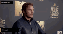 chris pratt is standing on a red carpet at the mtv movie awards