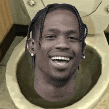 a man 's head is in a toilet and he is smiling