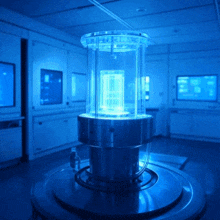 a blue light is shining on a glass cylinder in a room