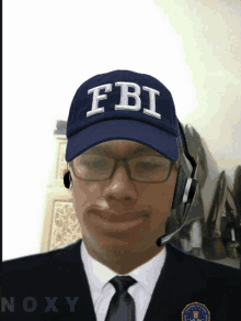 a man in a suit and tie has a fbi hat on