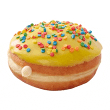 a donut with yellow frosting and colorful sprinkles on it