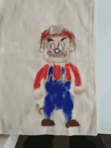 a child 's drawing of mario on a piece of fabric