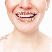 a woman has sprinkles on her teeth and smiles