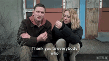 a man and a woman are sitting on the steps of a building with the words " thank you to everybody who "