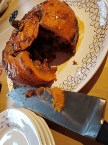 a knife is being used to peel a stuffed pumpkin