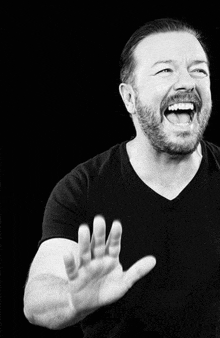 a black and white photo of a man laughing