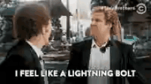 two men in suits are talking to each other and one of them is saying `` i feel like a lightning bolt ''